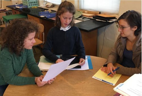 Maharishi School Iowa day student has a student-led conference with her mother and teacher.